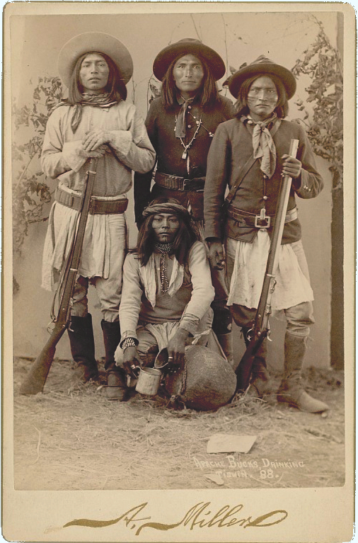 Apache scouts around 1888. One pours tiswin maize beer into a cup. Employed by the US Army to fight other Apaches